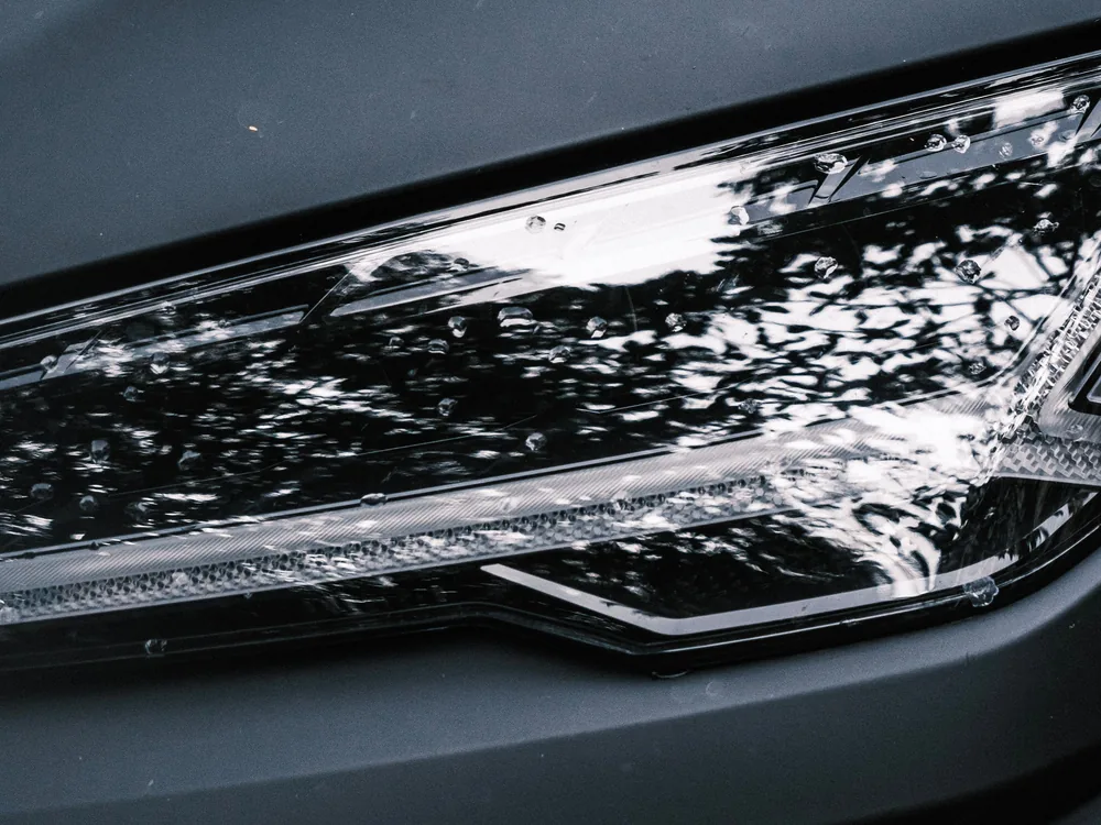 Close-up of a modern vehicle headlight and lens
